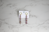 Light purple and lightweight acrylic earrings for women with eye-catching gold flecks and a hammered gold circle topper handmade by artisans in Charlotte, NC, USA.
