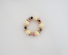 Channel your inner strength with the Sheila Agate Bracelet. Made with recycled paper beads of ivory, brass, green, and berry tones, this chunky bracelet features a powerful agate gemstone known to give courage and strength. Perfect for adding a touch of uniqueness and positivity to any outfit.