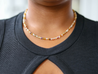 Lightweight and minimalist neutral and warm-toned necklace, handmade out of Agate gemstones and Heishi beads, by artisans overcoming trauma and injustice in Charlotte, NC.