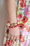 Woman wearing a hot pink and cranberry lightweight beaded bracelet handmade by artisans in Charlotte, NC, USA overcoming trauma and injustice.
