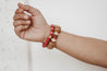 Woman wearing a chunky, warm-tone neutral bracelet handmade by artisans in Charlotte, NC, USA.