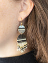 Woman wearing handmade iridescent beaded dangle earrings 