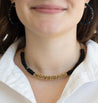 woman wearing black and gold beaded collar necklace