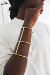 Long bar cuff in gold from Rwanda.