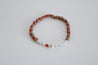 Red and multi colored beaded bracelet, letter Be Brave