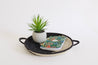 Handwoven yin yang basket made in Rwanda from natural fibers, fair trade decorative basket with black and cream spiral design, perfect for wall hanging or serving tray.