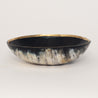 Elegant bowl handmade out of sustainably-sourced cattle horn, adorned with a brass inner rim