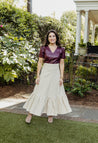 Textured 100% cotton, cream-colored wrap skirt with one tier at the bottom sewn in the USA