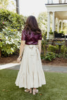 Textured 100% cotton, cream-colored wrap skirt with one tier at the bottom sewn in the USA