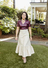 Textured 100% cotton, cream-colored wrap skirt with one tier at the bottom sewn in the USA
