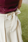 Textured 100% cotton, cream-colored wrap skirt with one tier at the bottom sewn in the USA