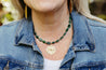 Handmade, short beaded necklace with emerald green Aventurine semi-precious gemstone beads and a gold-plated starburst pendant