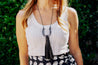 Adjustable cord necklace with cattle horn pendant and genuine leather tassel