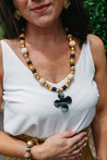 Gold, cream, and black chunky necklace.