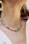 Tonal blue, green, and brown beaded necklace with sea glass pendant in center