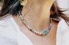 Tonal blue, green, and brown beaded necklace with sea glass pendant in center