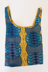 Reusable bag with blue and yellow geometric pattern with circular patterns and striped details.
