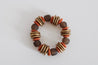 Ethically made fall wooden bracelet featuring warm copper discs and earthy brown beads.