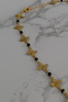 close up of dainty gold flower necklace