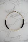 black and white beaded collar necklace on brass cord