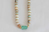 Tonal blue, green, and brown beaded necklace with sea glass pendant in center