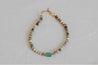 Tonal blue, green, and brown beaded necklace with sea glass pendant in center