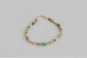 Tonal blue, green, and brown beaded necklace with sea glass pendant in center