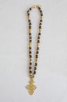 Neutral long handmade necklace featuring a coptic cross pendant