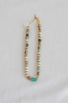 Tonal blue, green, and brown beaded necklace with sea glass pendant in center