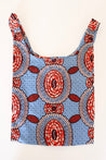 Red and blue reusable tote bag with bold oval African-inspired patterns, eco-friendly and stylish for everyday use.