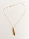 Minimalist, hand-assembled necklace with a gold-plated script charm on an 18k gold filled chain