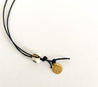 Handmade cotton cord long necklace with a textured brass cross pendant