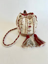 White, tan, red, light blue, and white hand-crocheted bucket bag