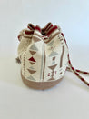 White, tan, red, light blue, and white hand-crocheted bucket bag