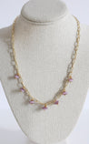Gold chain necklace with lavender pendants.