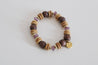Handcrafted bracelet with lilac glass beads and natural wood accents.