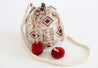 White, red, gray, tan, and light blue hand-crocheted bucket bag