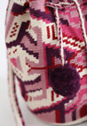 Pink, purple, and white hand-crocheted bucket bag with pom poms