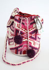 Pink, purple, and white hand-crocheted bucket bag with pom poms