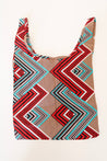 Tote bag with vibrant geometric pattern in red, teal, black, and beige