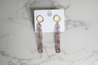 Light purple and lightweight acrylic earrings for women with eye-catching gold flecks and a hammered gold circle topper handmade by artisans in Charlotte, NC, USA.