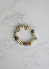 Beaded bracelet featuring recycled glass beads and neutral colors, handmade by artisans in Charlotte, NC, USA.