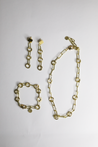 Bundle of gold chainlink necklace, bracelet, and earrings