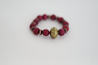 Vicki Plum Bracelet - a chunky accessory perfect for any boho babe! Made with jewel-toned plum stones and Indian brass, this bracelet adds a touch of ethnic flair to any outfit. Spice up your jewelry game (and wardrobe) with this unique piece! 