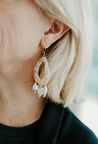  Lightweight pink acrylic dangle earrings with three dangling ivory wood detail beads, hand- assembled by artisans in Charlotte, NC, USA.