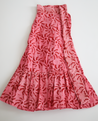 1-tiered wrap skirt. Bright pink with meroon sun pattern.