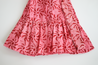 1-tiered wrap skirt. Bright pink with meroon sun pattern.