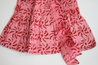 3-tiered wrap skirt. Bright pink with meroon sun pattern.