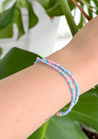 Minimal bracelet with blue and pink beads.