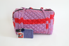 Pink and red duffle bag with lavender small pouch.